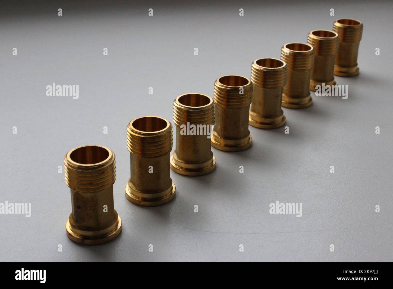 Copper Threaded Fittings For Water Pipe Connection Lined Up On White