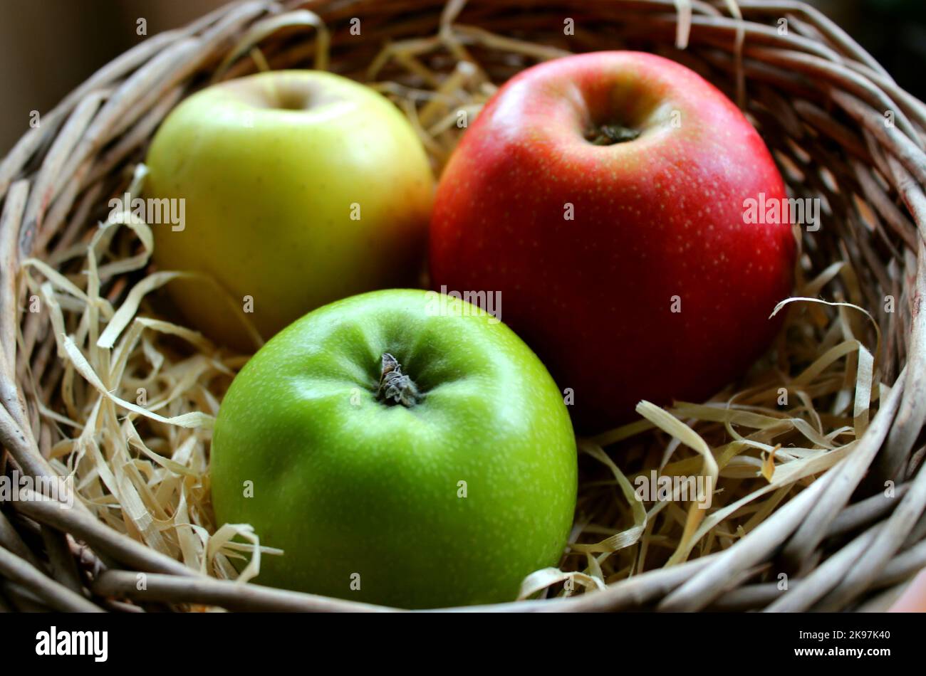 Gala Apple, Granny Smith Apple And Golden Delicious Apple Lie Side By Side In A Wicker Basket Stock Photo