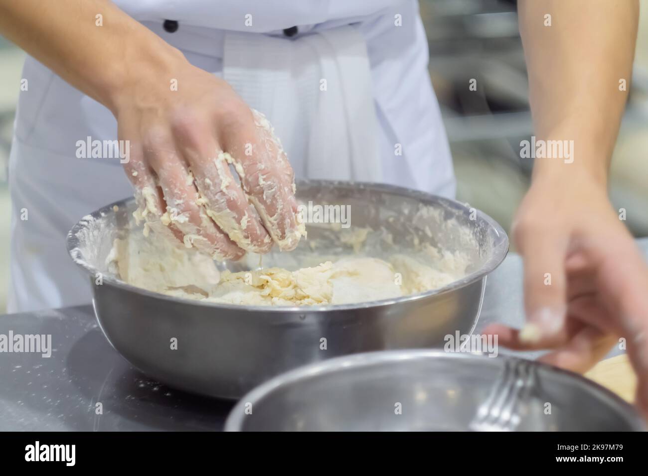 Baker, chef hands kneading fresh dough in steel bowl Stock Photo - Alamy