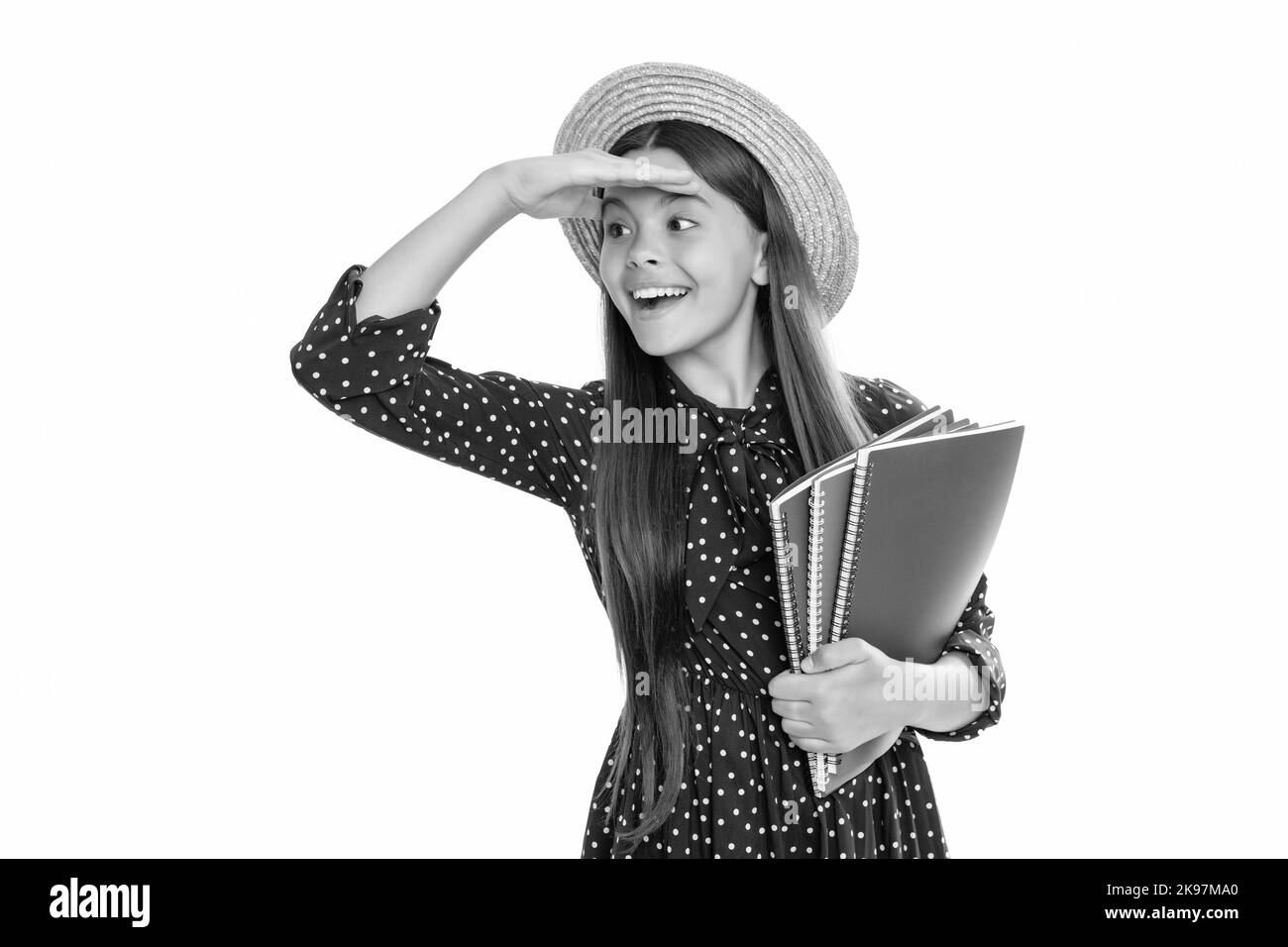 happy teen girl in straw hat hold school workbook for studying isolated on white, school time. Stock Photo