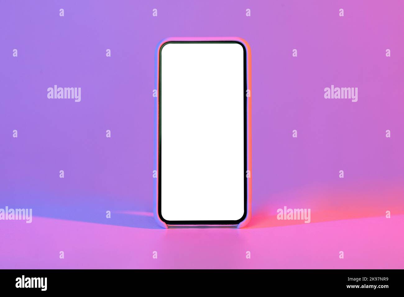Modern phone with blank white screen, isolated on neon background Stock Photo