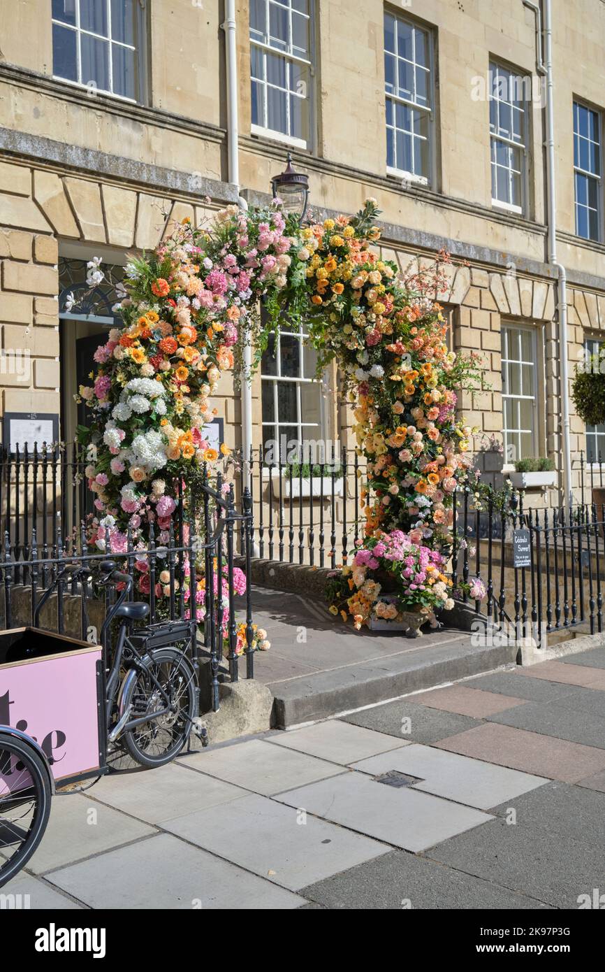 Hotel entrance arch garlanded with flowers in Great Pulteney Street Bath Somerset England UK Stock Photo