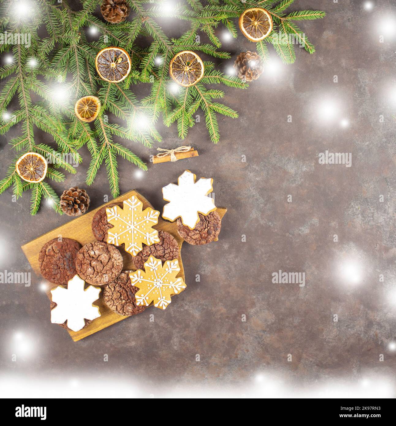 Christmas gingerbread cookies in the form of snowflakes. Fir branches. Top view flat lay. copy space Stock Photo