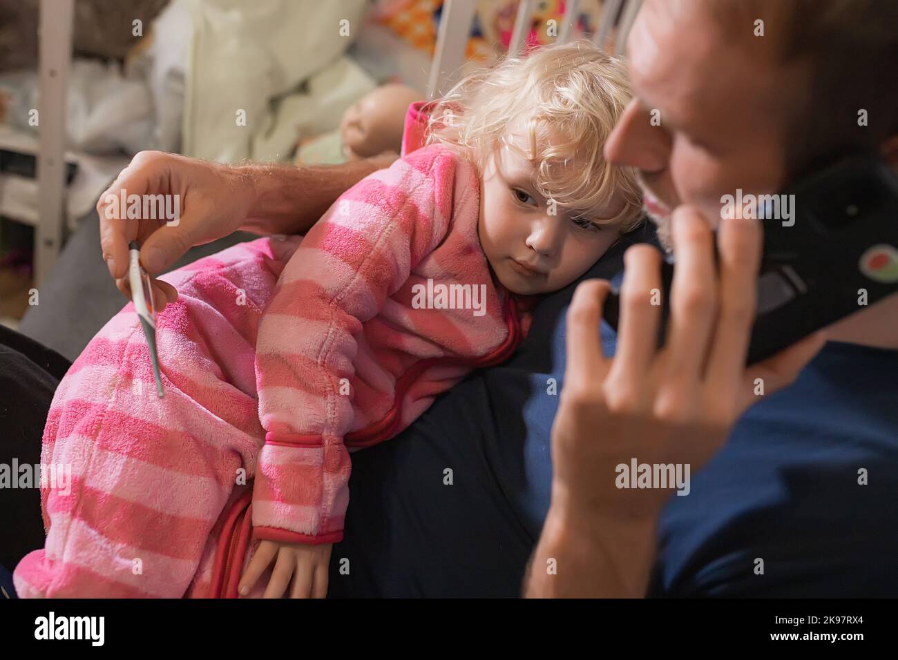 child in arms of loving father during illness. Fever in 3-year-old child. girl's respiratory disease, supported by father, takes care, helping to redu Stock Photo