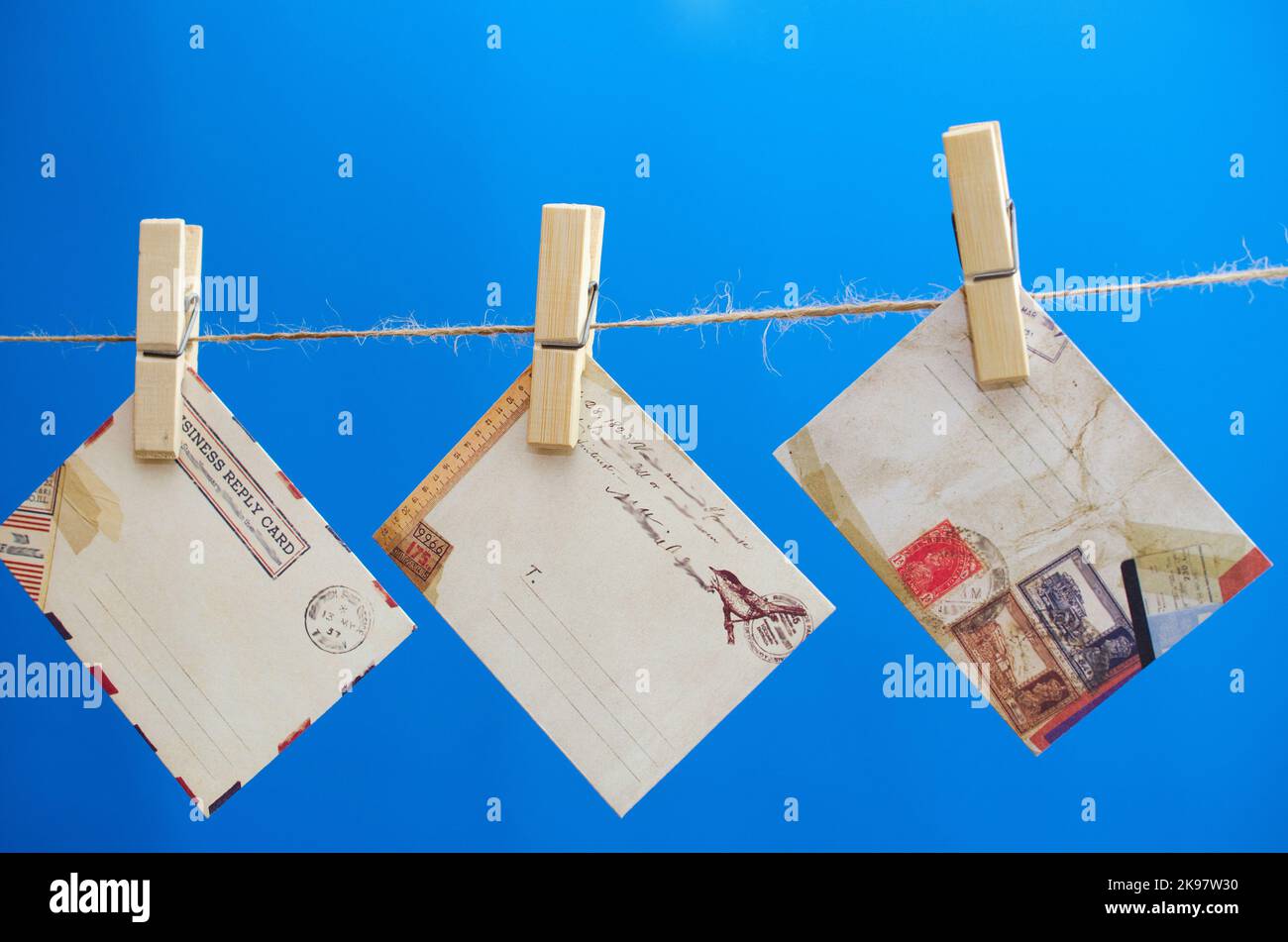 Envelopes of the message on a rope on a blue background Stock Photo