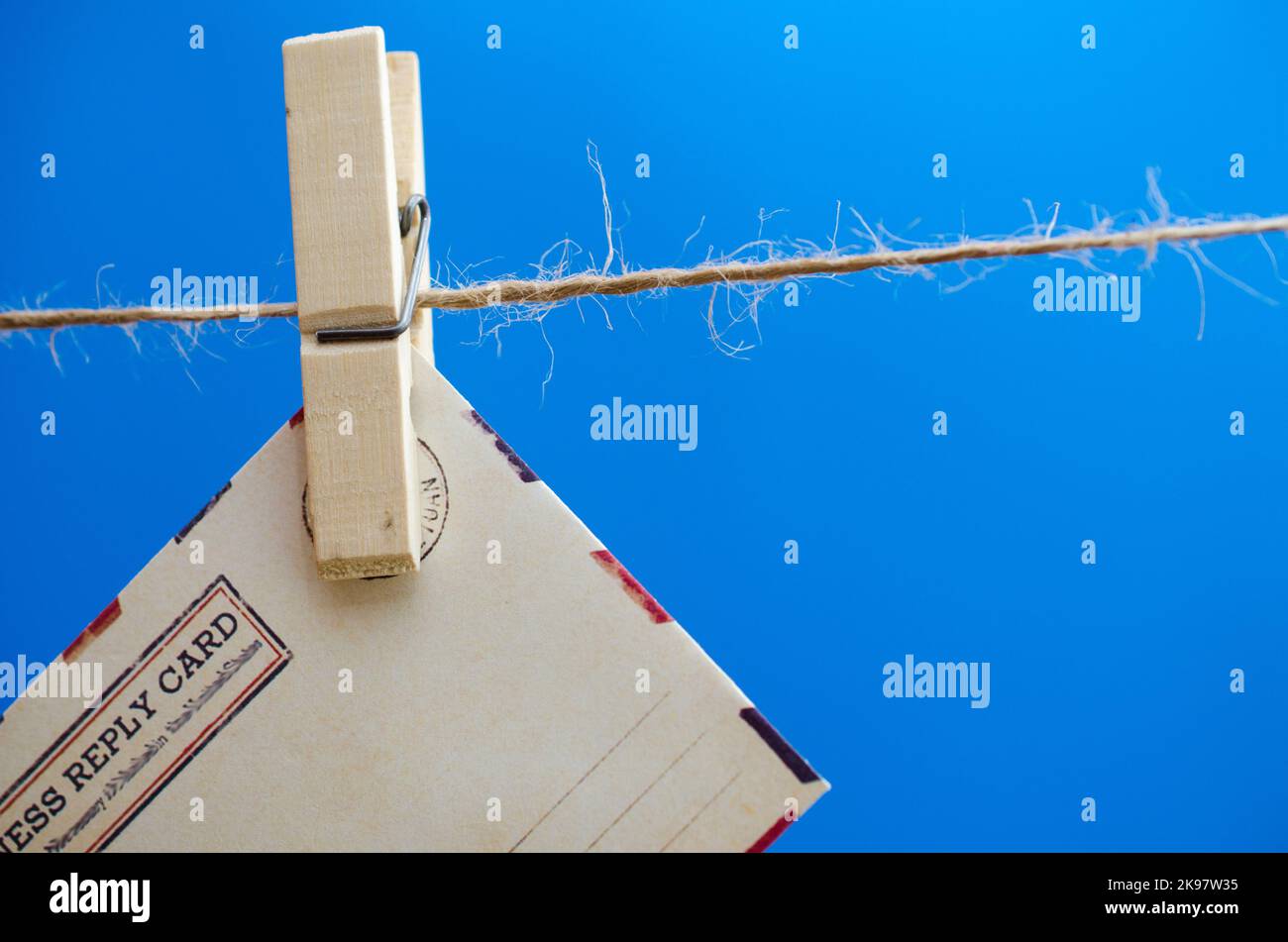Envelopes of the message on a rope on a blue background Stock Photo
