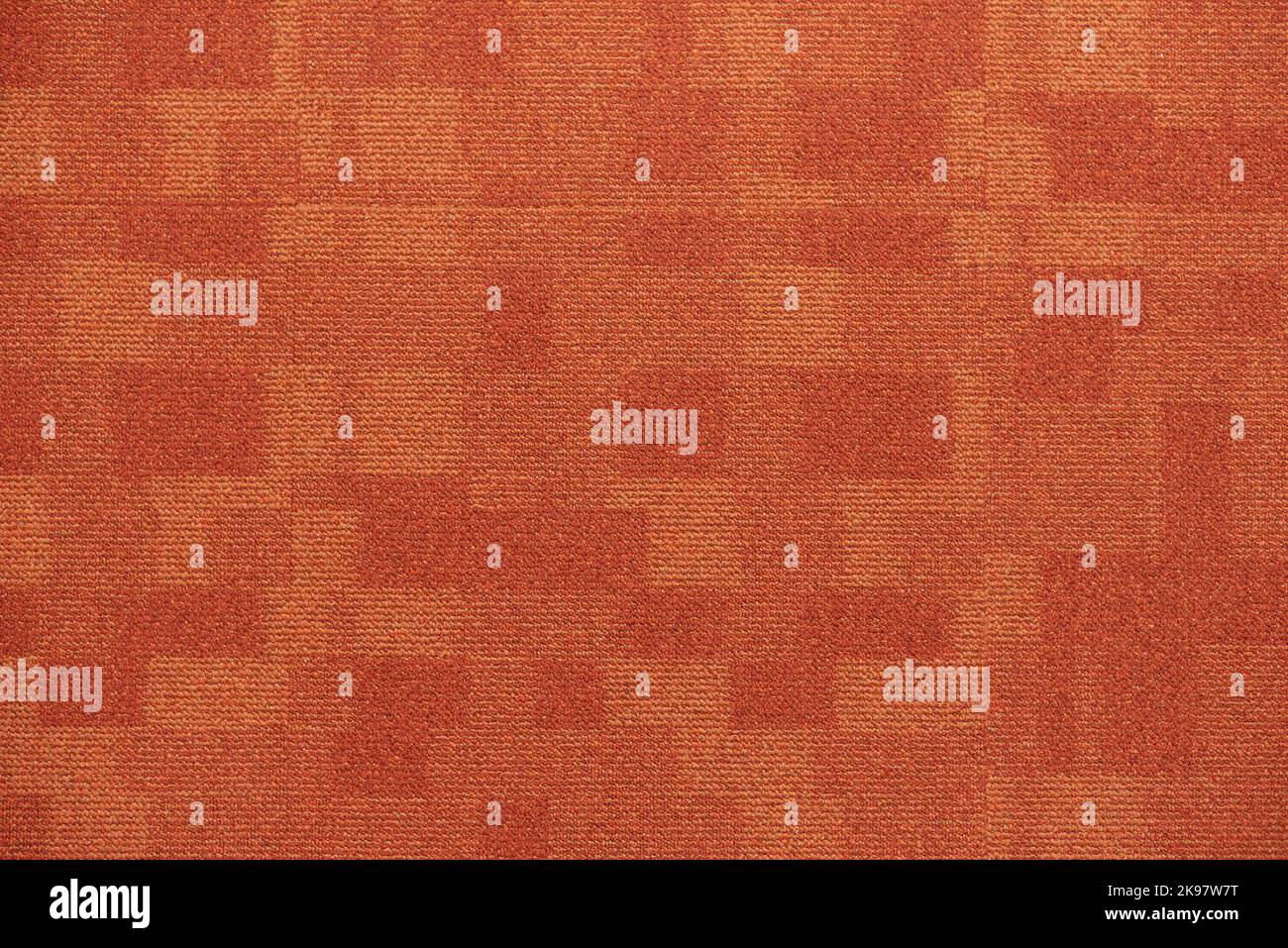 Texture carpet covering, red with a pattern of squares. Stock Photo