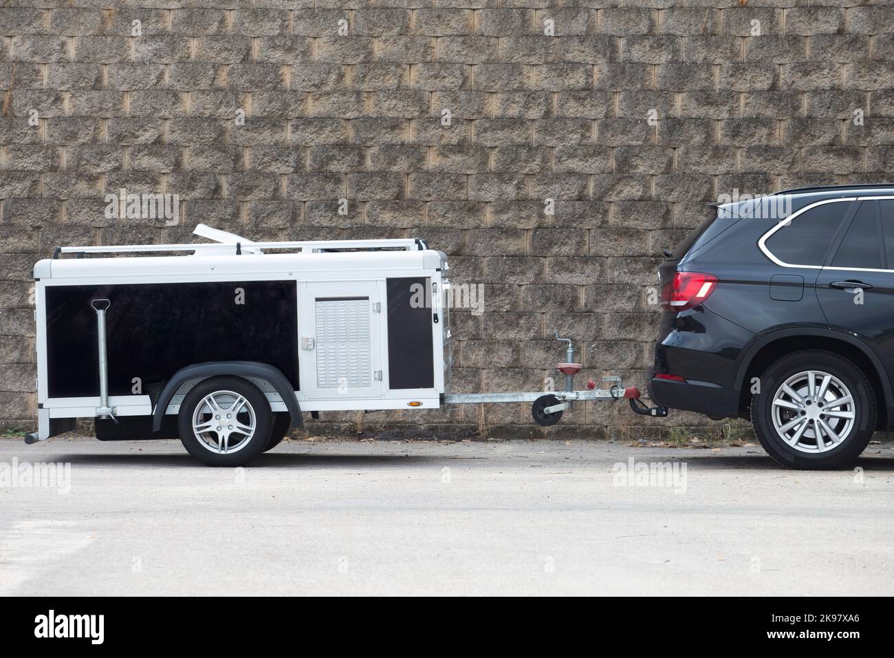 Parked travel dog trailer. All-road vehicule hooked Stock Photo