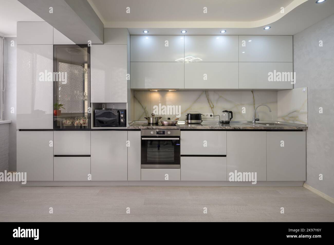 Interior of modern trendy white kitchen, front view Stock Photo