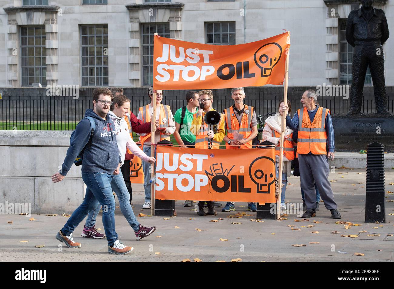 Westminster, London, UK. 26th October, 2022. Just Stop Oil Protesters including climate activist Dr Larch Maxey, were protesting outside Downing Street again today. Just Stop Oil is a coalition of groups working together to ensure that the Government commits to ending all new licenses and consents for the exploration, development and production of fossil fuels in the UK. As part of their campaigning, JSO activists have been spraying orange paint across buildings in London and blocking roads. Credit: Maureen McLean/Alamy Live News Stock Photo