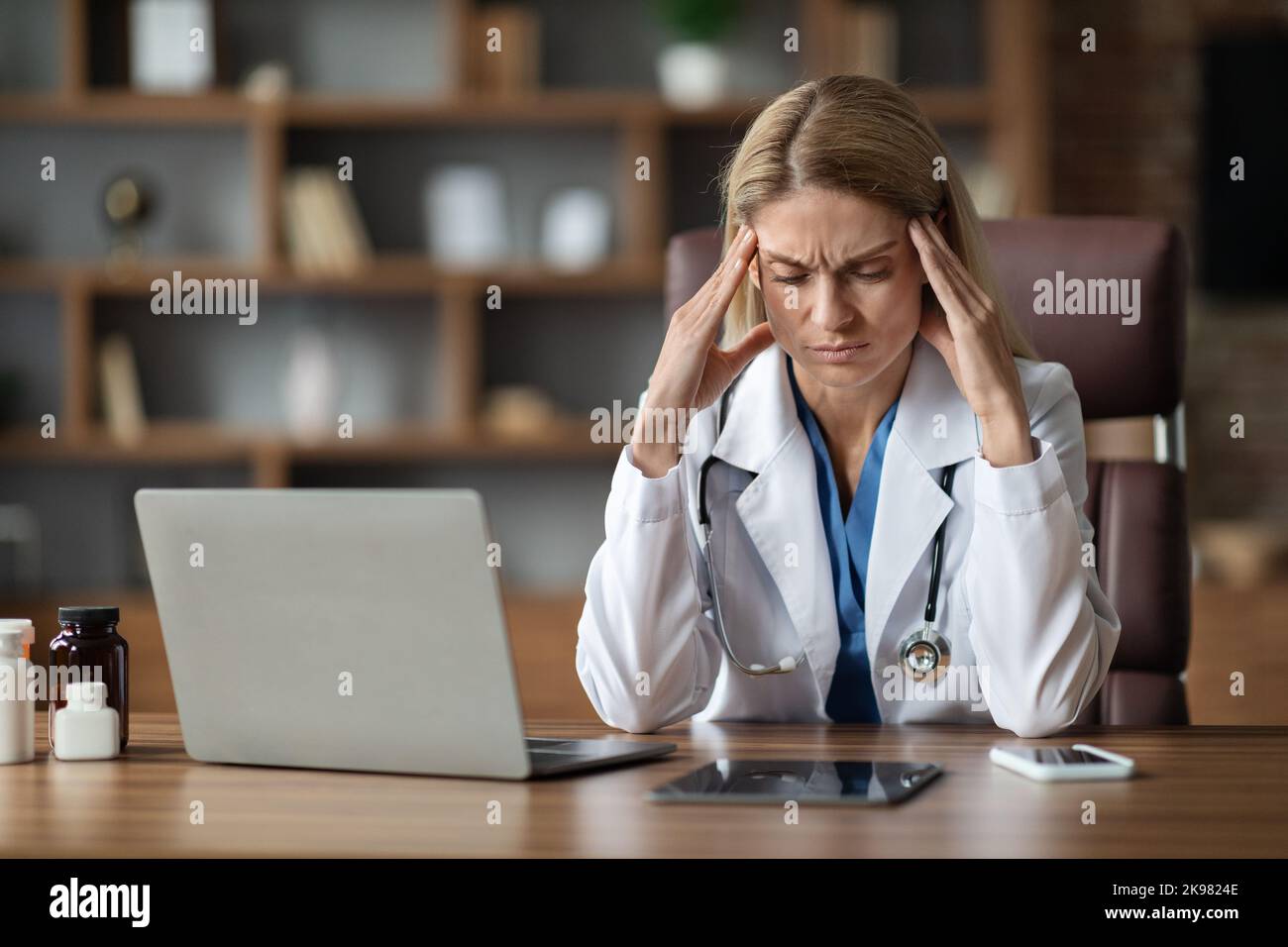 Portrait Of Stressed Female Doctor In Uniform Suffering Headache At ...