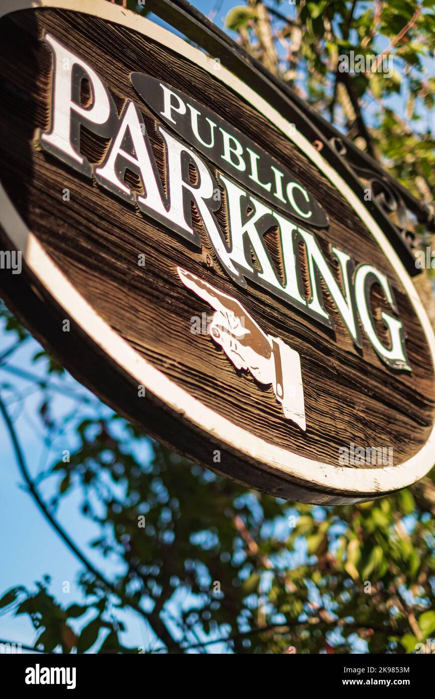 Aged and worn vintage parking sign. Wooden public parking sign. Nobody ...