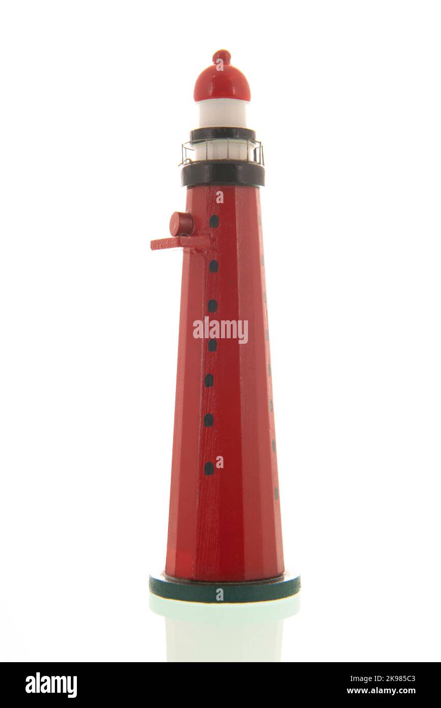 Red wooden miniature lighthouse isolated over white background Stock ...