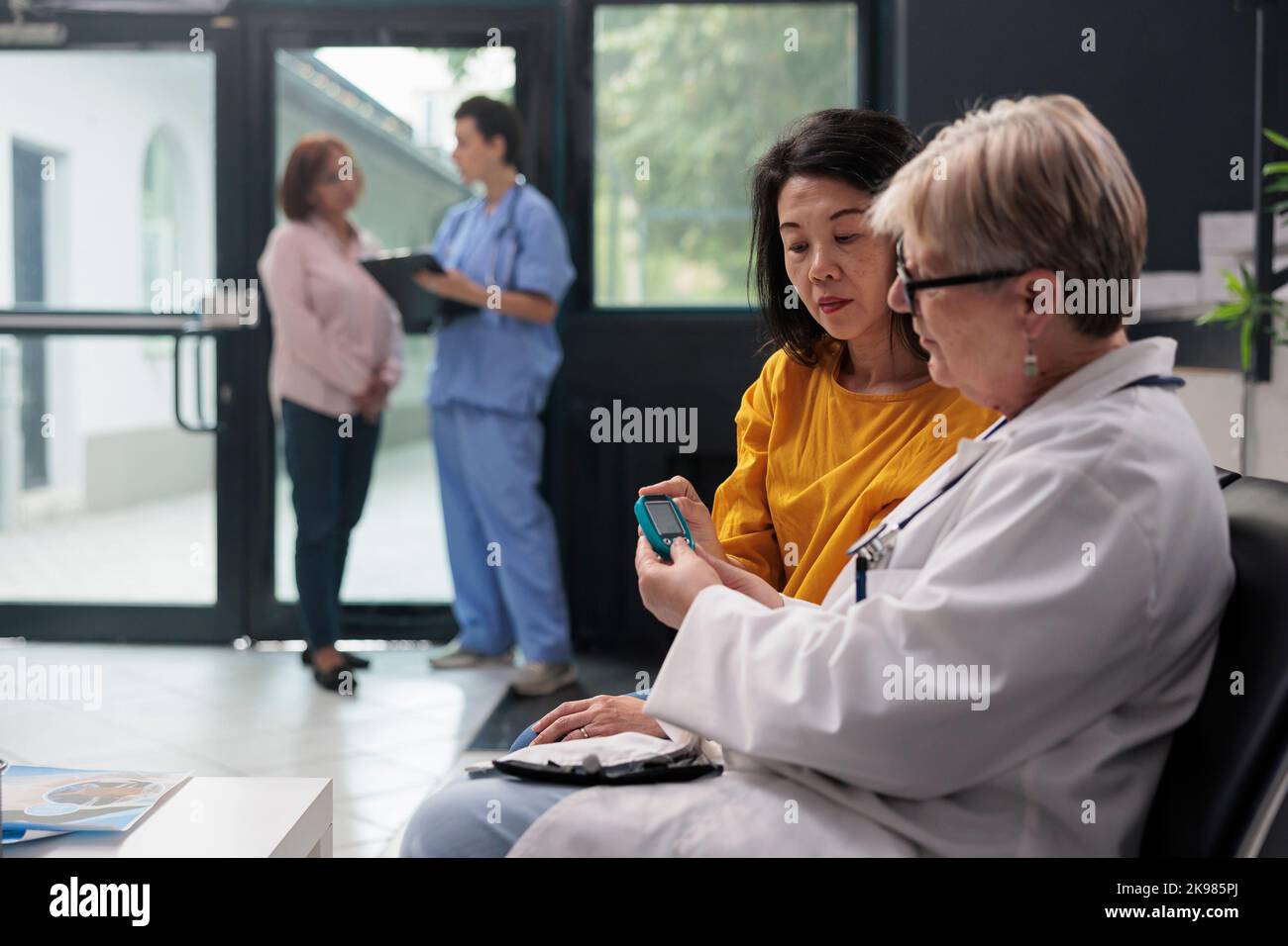 Senior physician consulting asian patient with measuring