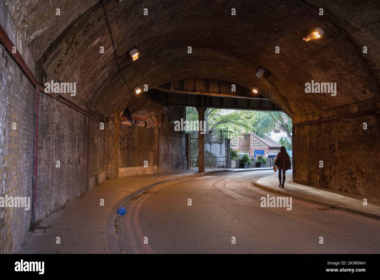 Vulnerable lone woman walking home Bermondsey London Stock Photo