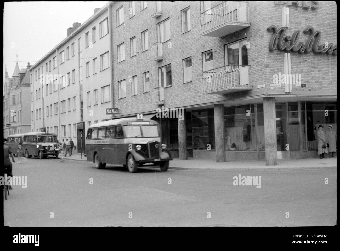 Bus in traffic and at the stop intersection S: t Larsgatan - Drottninggatan in Linköping. Stock Photo