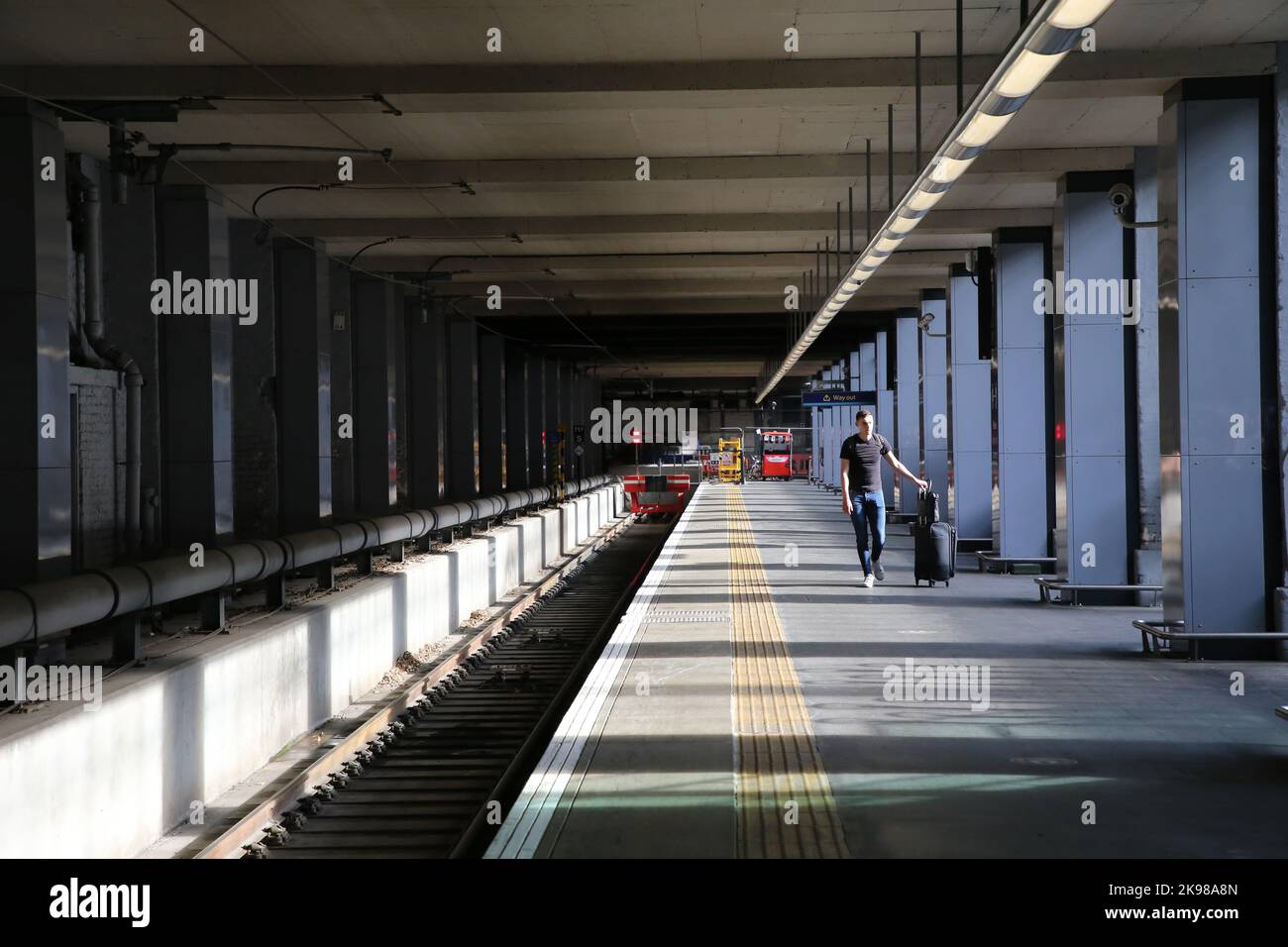 Kings Cross Station London with empty platform and a single passenger Stock Photo Alamy