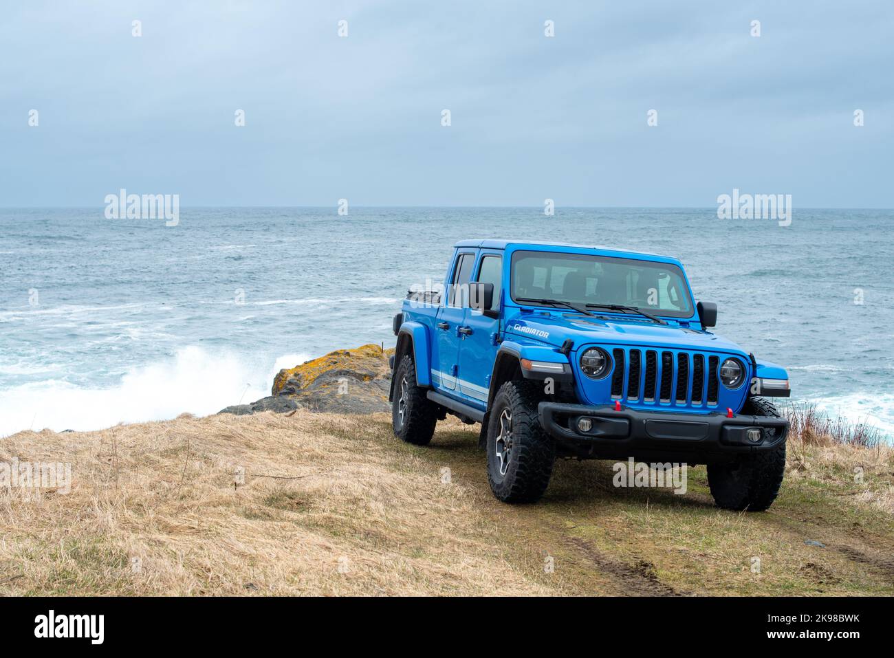 St. John's, Newfoundland, Canada, August 2022: A vibrant blue Jeep Gladiator Rubicon truck 4x4 off road and parked on an old airport runway. Stock Photo