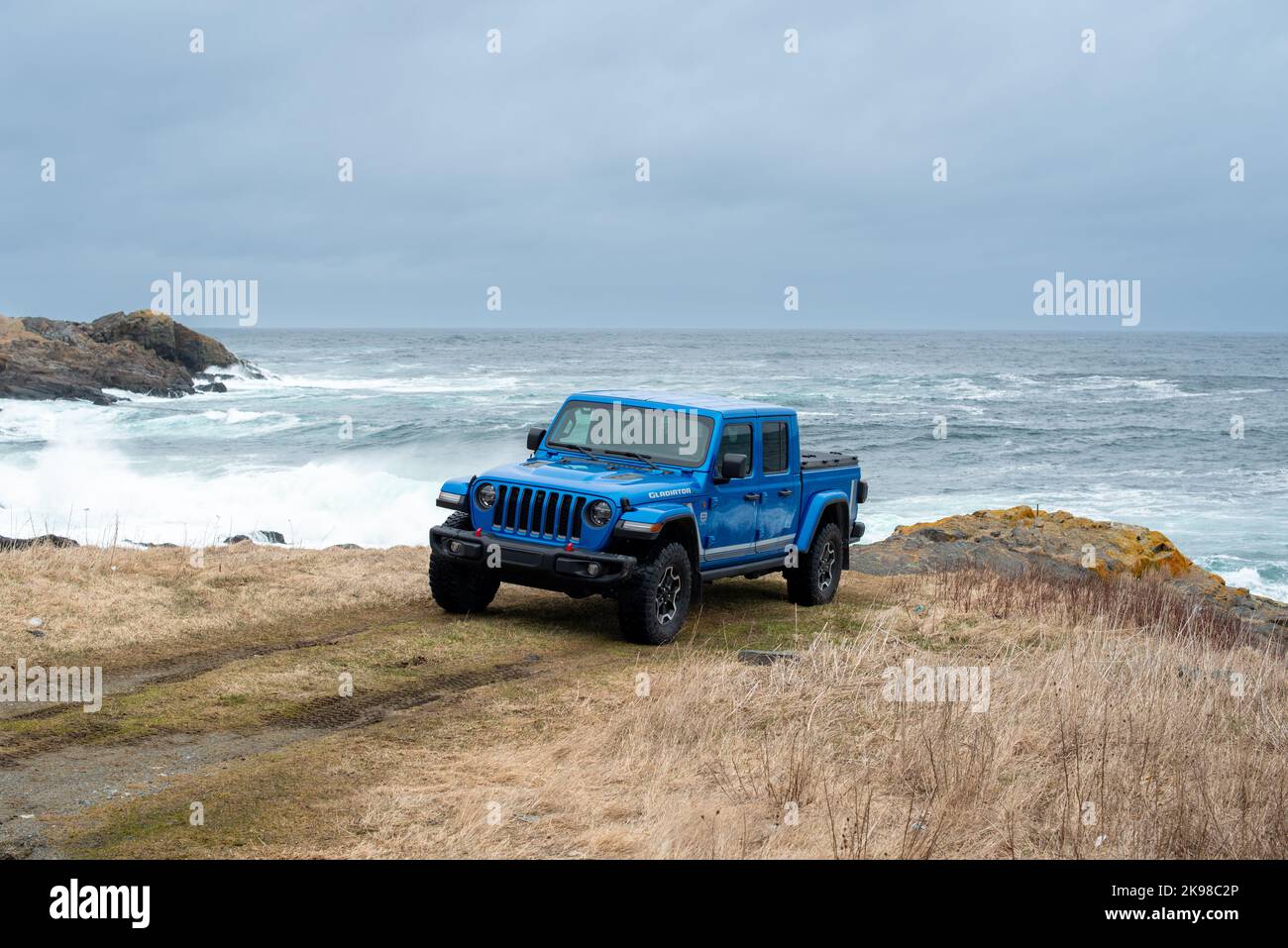St. John's, Newfoundland, Canada, August 2022: A vibrant blue Jeep Gladiator Rubicon truck 4x4 off road and parked on an old airport runway. Stock Photo