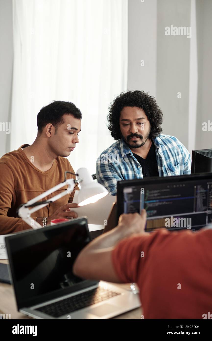 Programmers discussing new releasing new feature on website Stock Photo