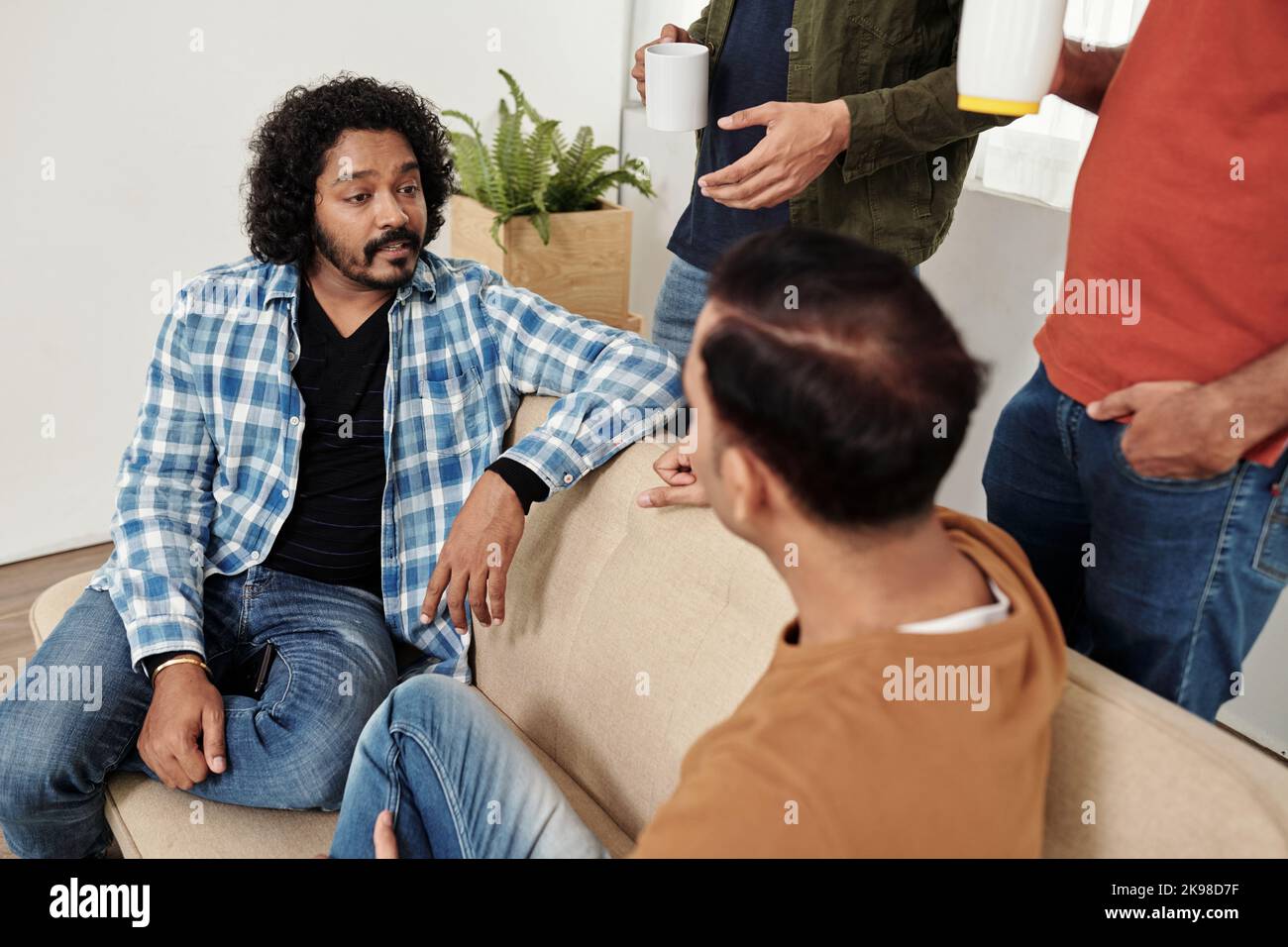 Team leader taking to developers during coffee break Stock Photo