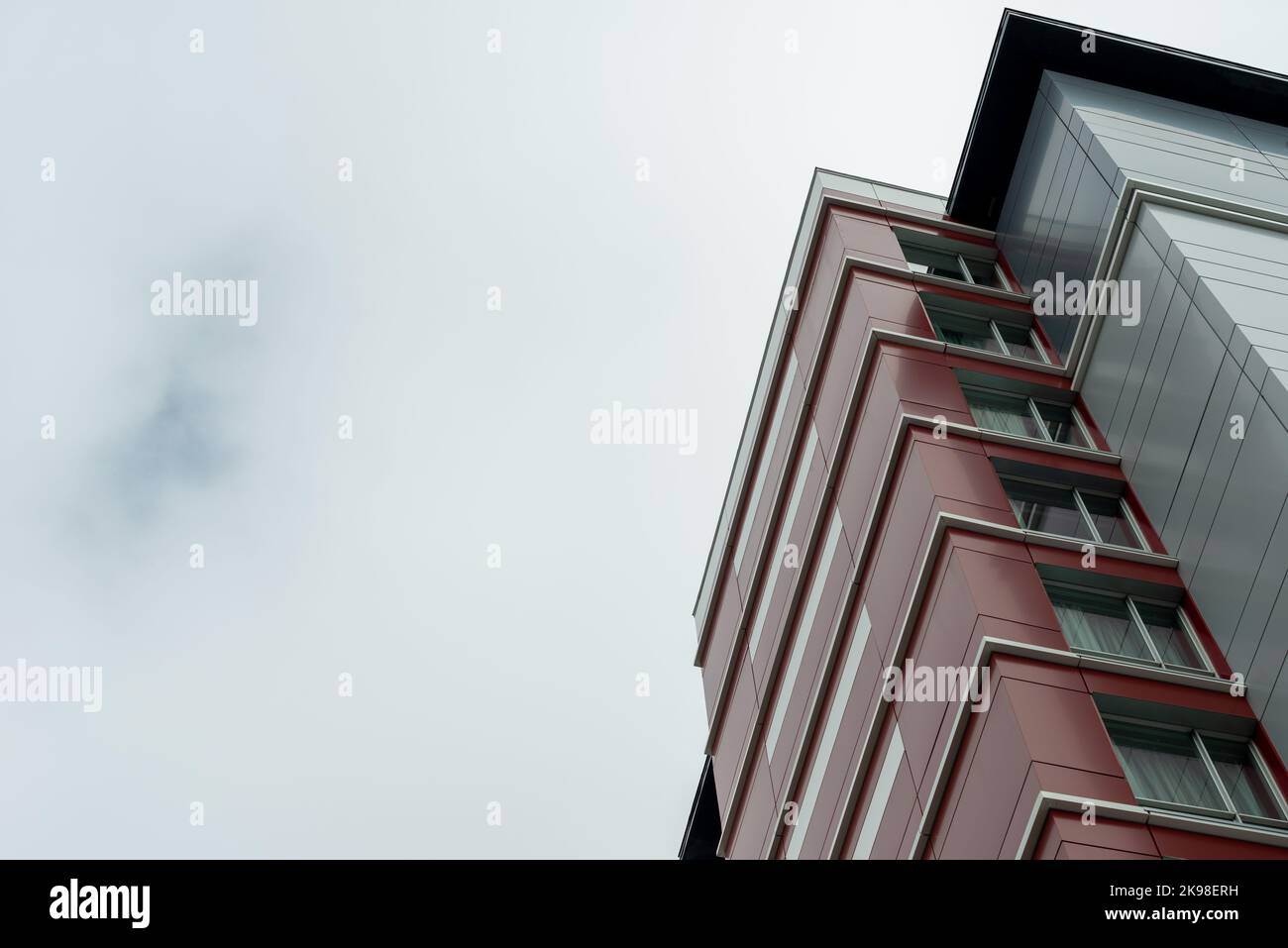 The exterior wall of a contemporary commercial style building with aluminum metal composite panels and glass windows. The futuristic building Stock Photo