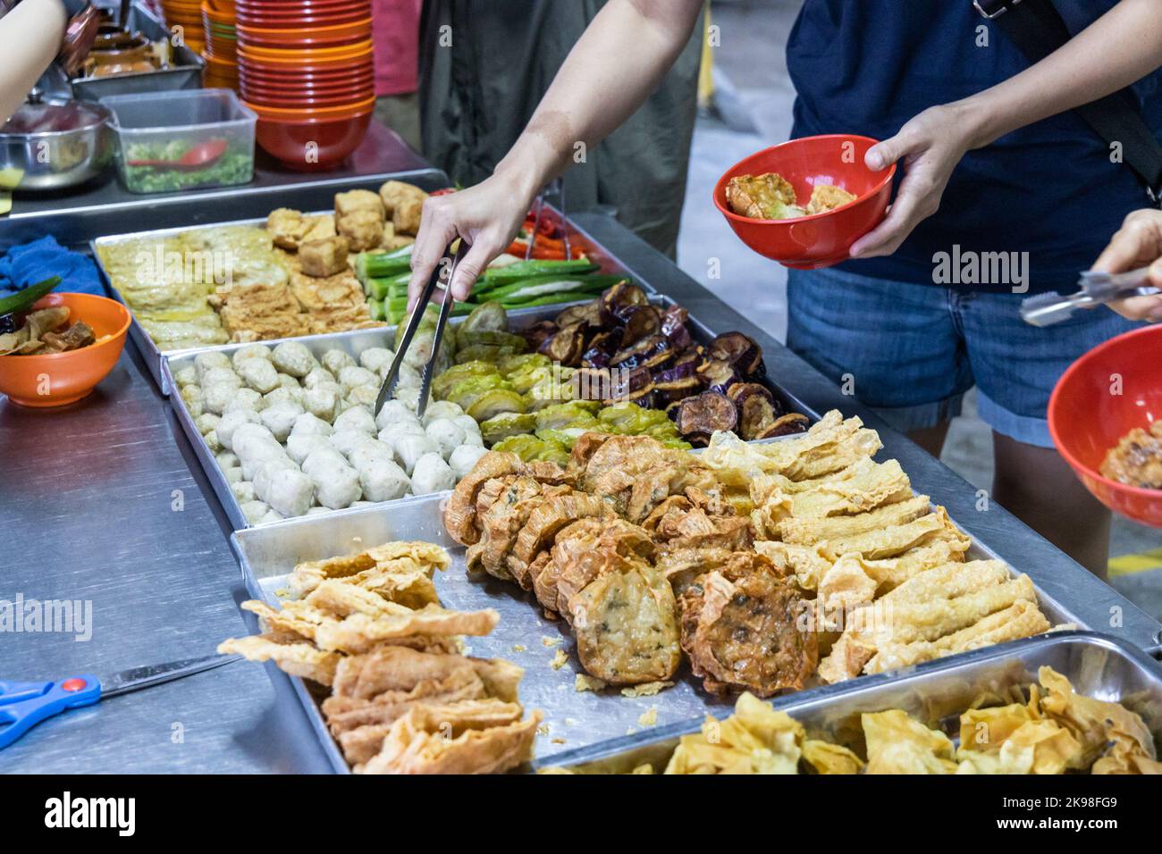 People selecting yong tau foo, delicious fried stuffed fish paste into