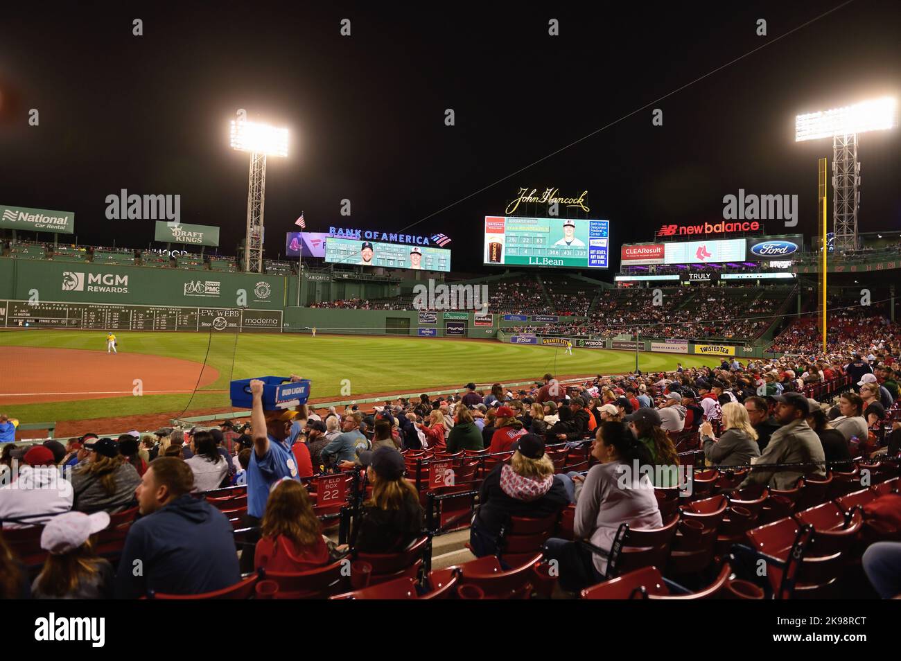 Boston, Massachusetts, USA. Fans on game night at Fenway Park. Beyond the 'triangle' in the outfield are modern, electronic message boards. Stock Photo