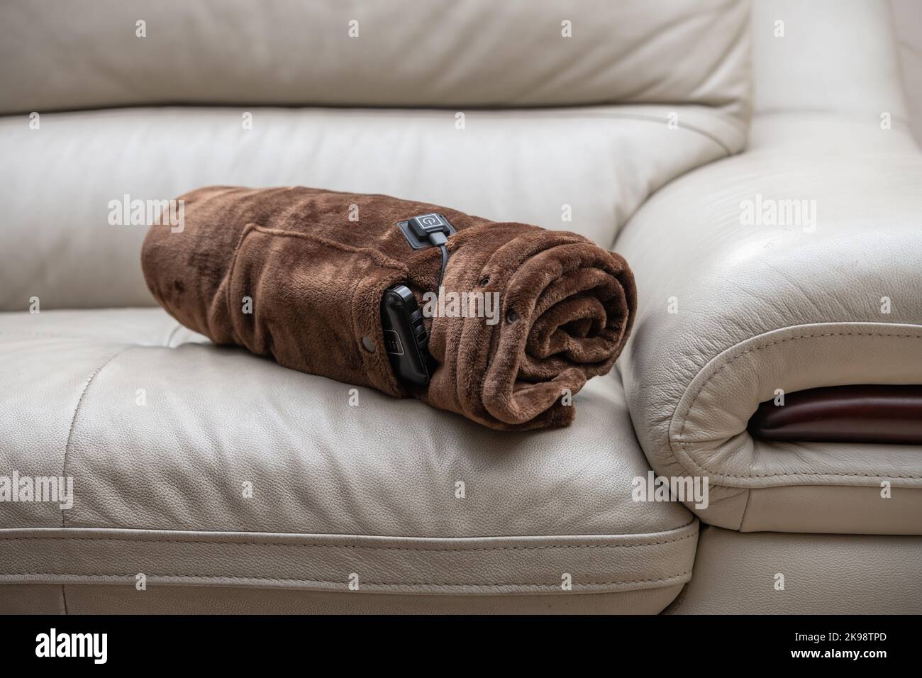 rolled up electric blanket with portable charger as a power supply on a