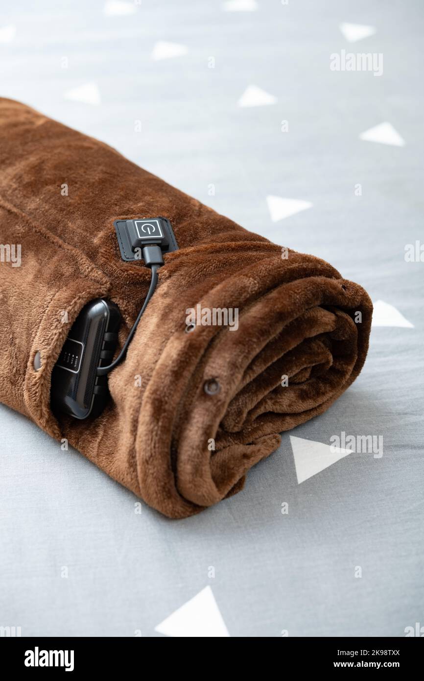 angle view rolled up electric blanket with portable charger as a power