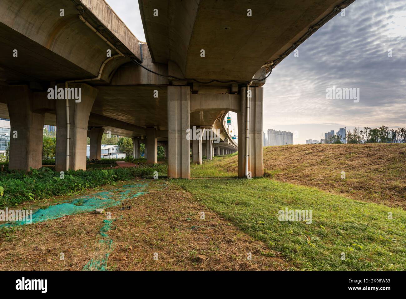 Grass under the overpass,Freeway, overpass and junction with green grass Stock Photo