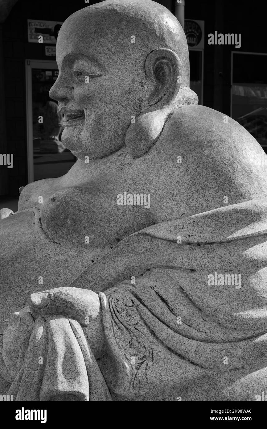 Close up of Happy and fat buddha Budai. Budai is Commonly Known as the Laughing Buddha-Alberni BC Canada-October 5,2022. Travel photo, nobody Stock Photo