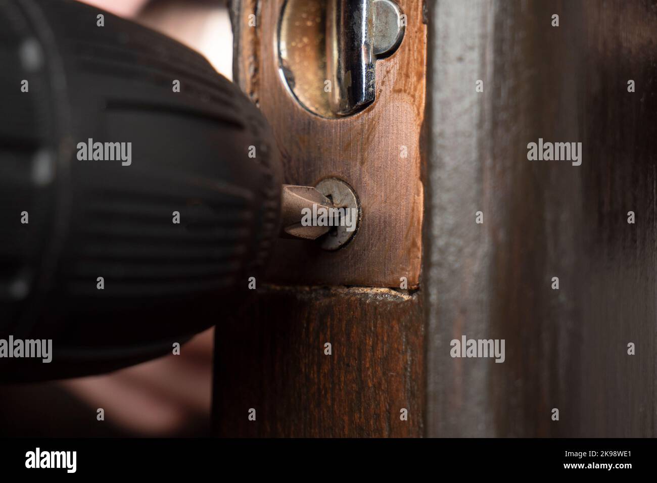 installation replacement of the door lock with a screwdriver Stock