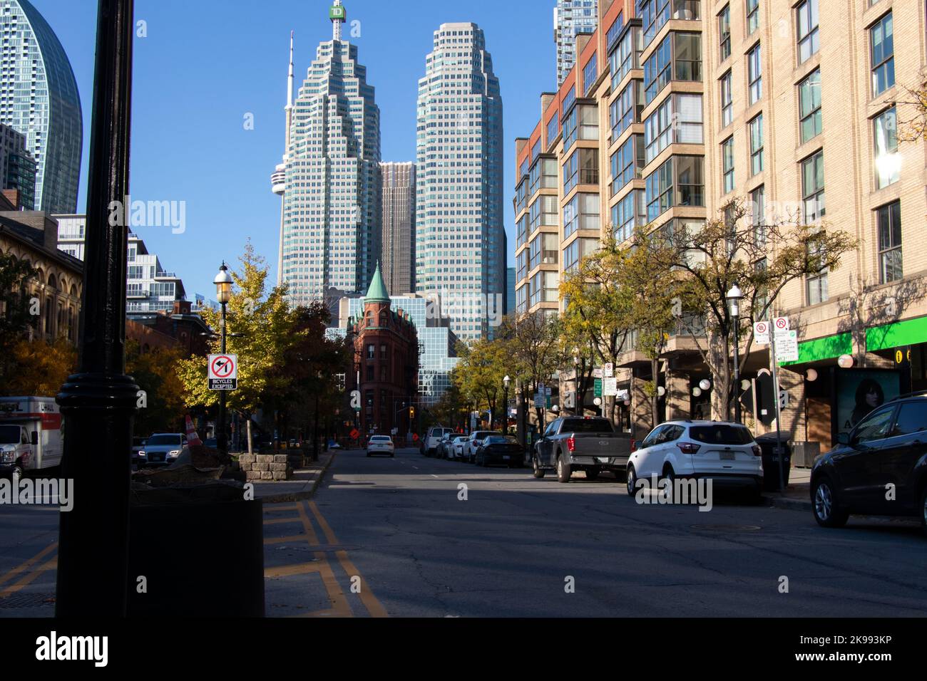 The famous Toronto skyline of Front Street is seen in the early morning, looking down the street at the famous Gooderham Building on a fall day. Stock Photo