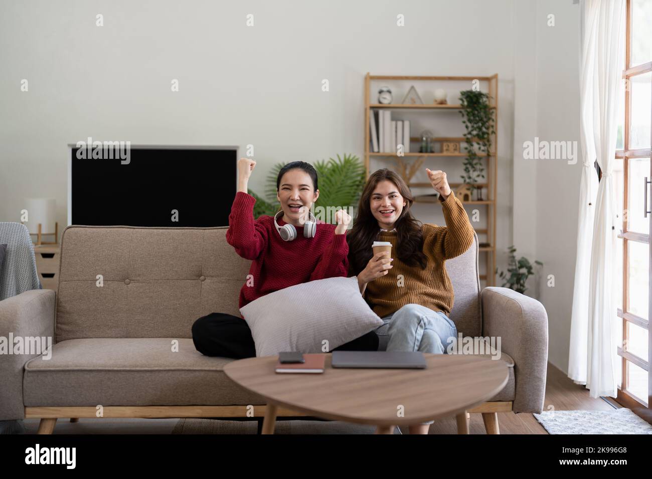 Multiethnic Group Of Young Woman Having Fun, Watching TV Stock Photo