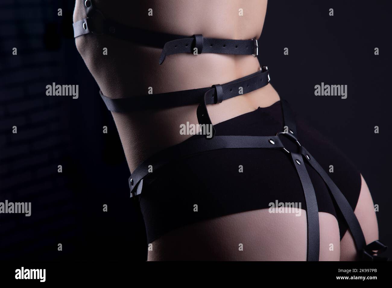 Photo of girls body in bdsm belt Stock Photo