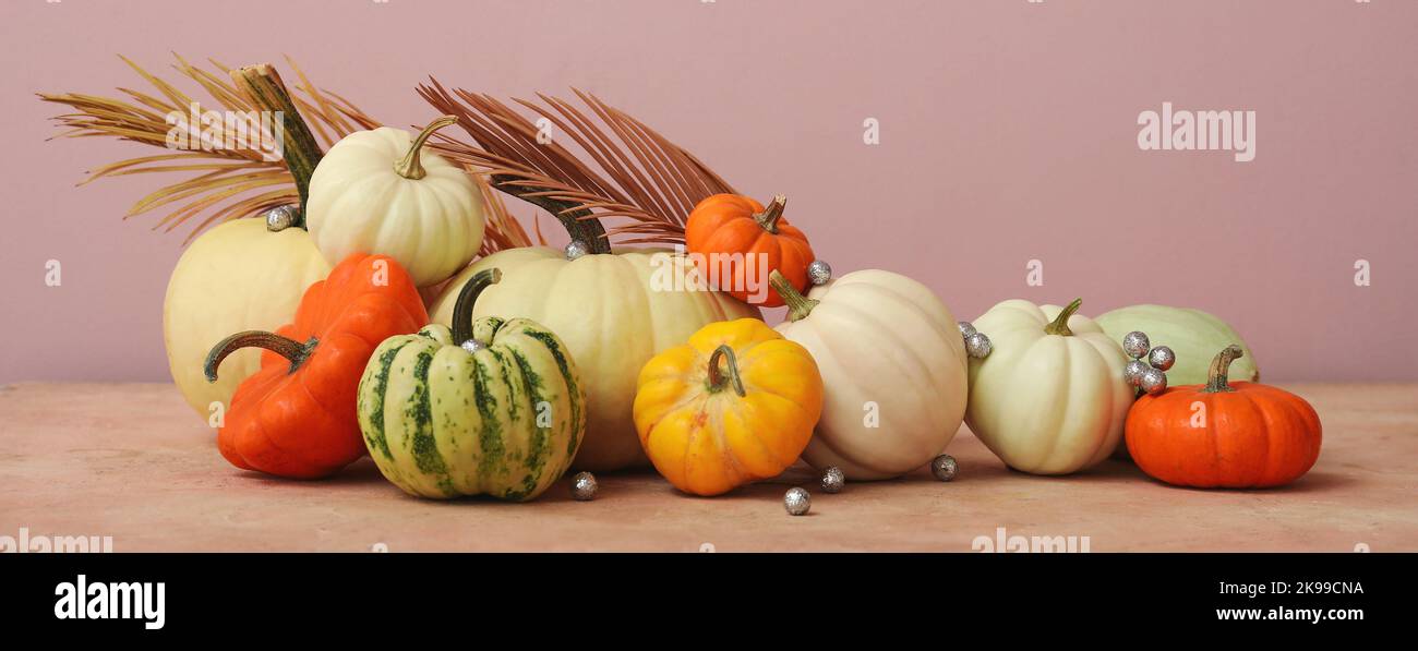 Composition with pumpkins and decor on pink background Stock Photo - Alamy