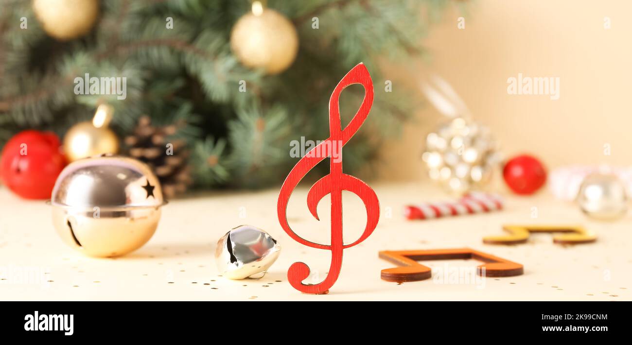 Music notes with Christmas decorations on light background Stock Photo