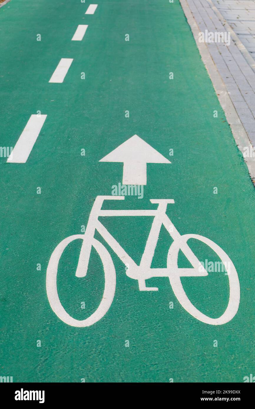 Bicycle sign with direction arrow outdoors Stock Photo - Alamy
