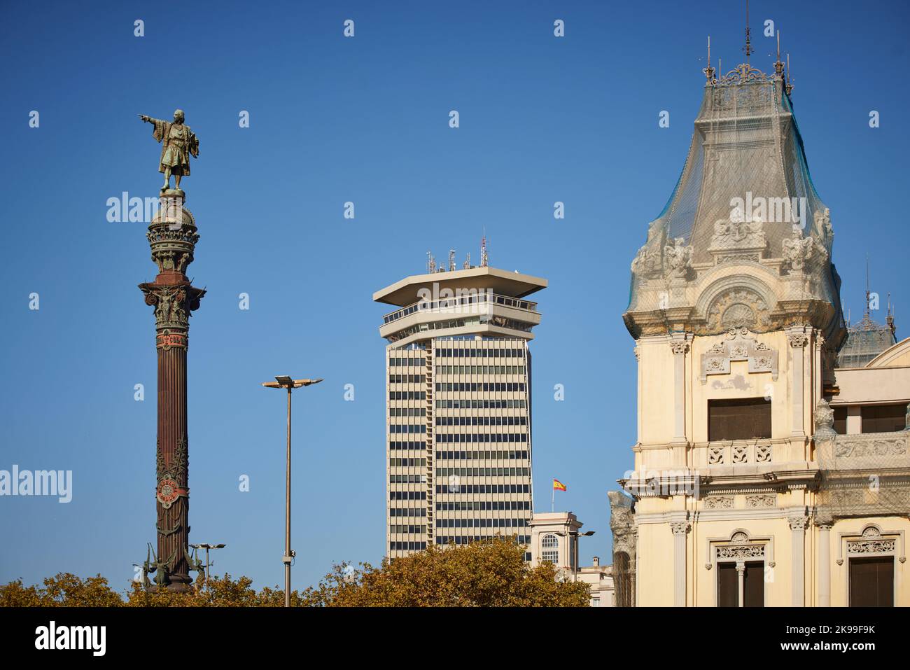 Catalonia capital city Barcelona in Spain. Edifici Colón  a office skyscraper and El Mundial Palace O Estación Marítima, Columbus Monument Stock Photo