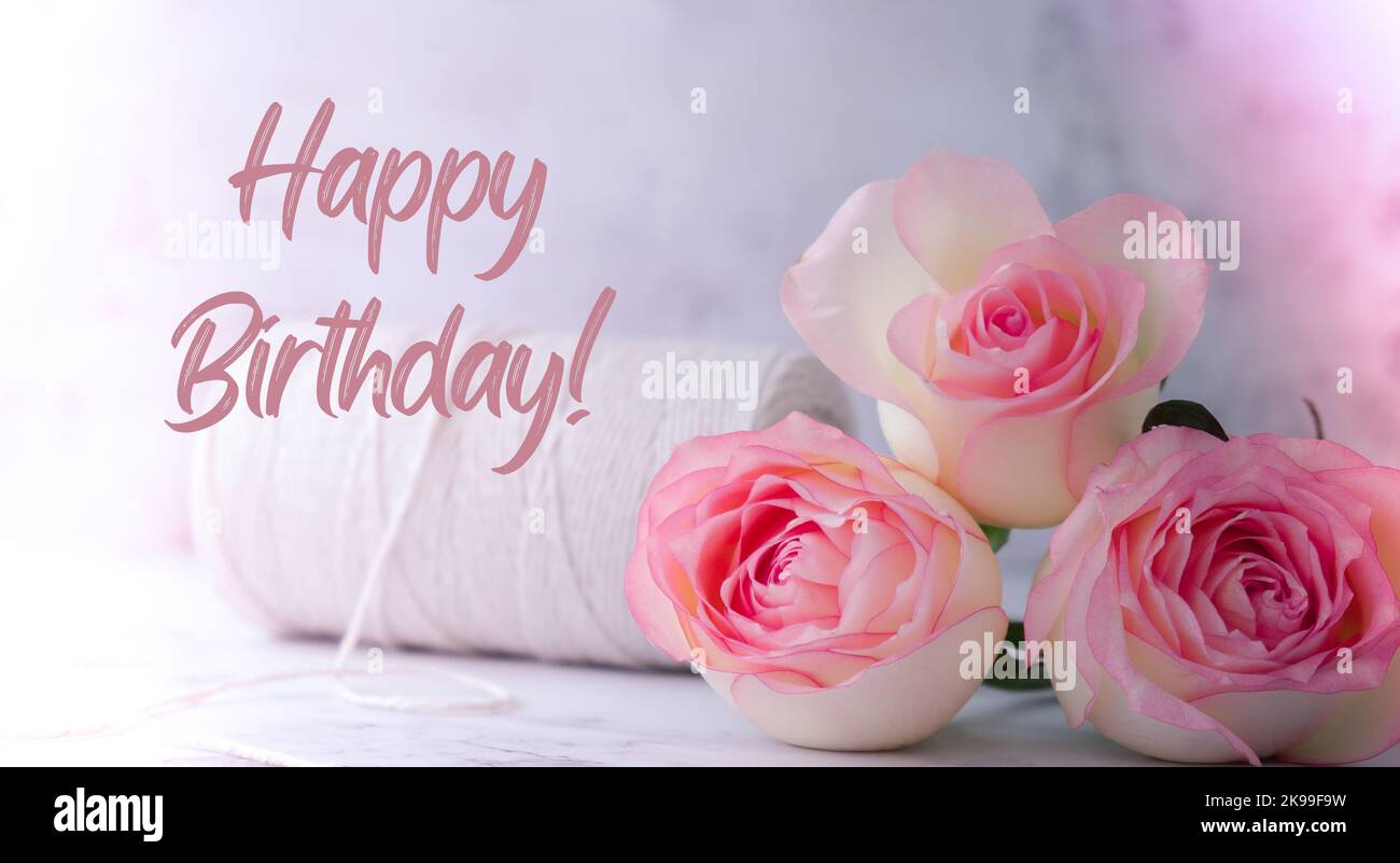 Delicate pink roses with spool of white cotton rope. Minimal trendy ...