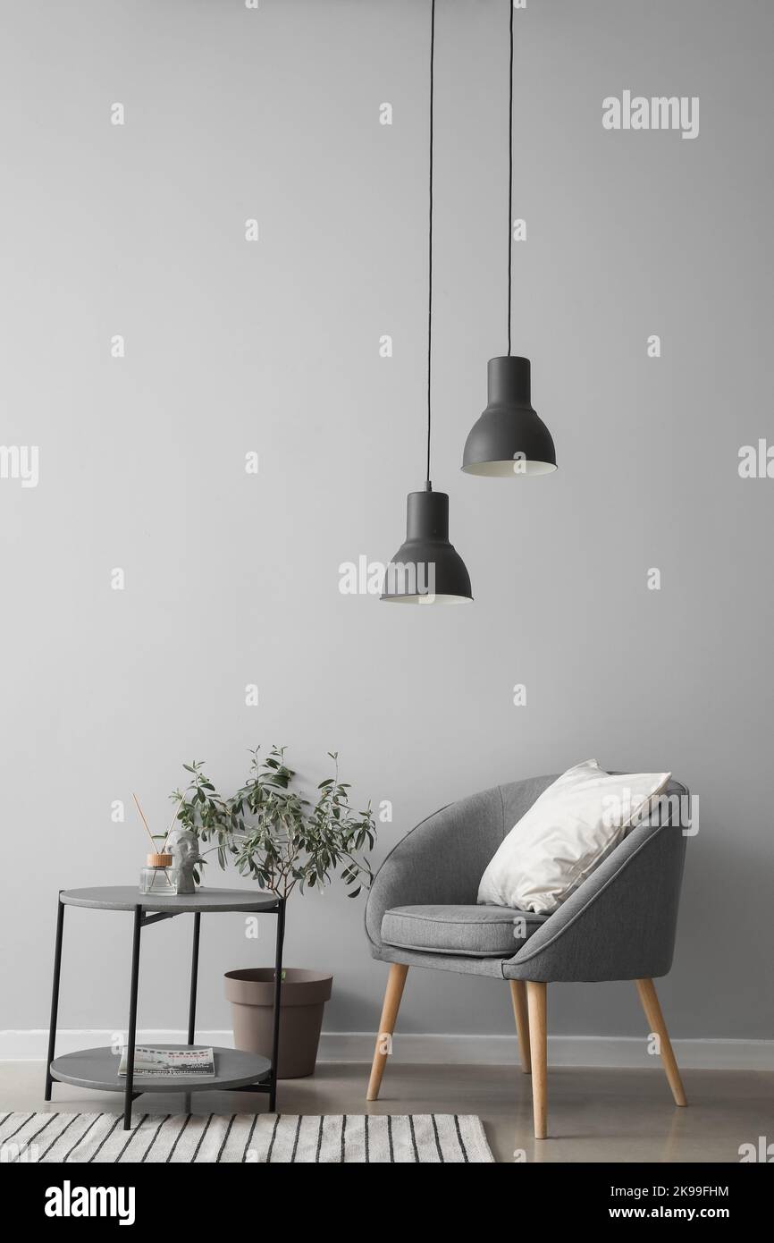 Interior of modern living room with armchair and table Stock Photo - Alamy