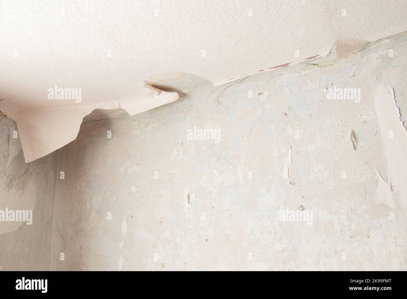 removing old paper wallpaper from the wall in a room of a residential