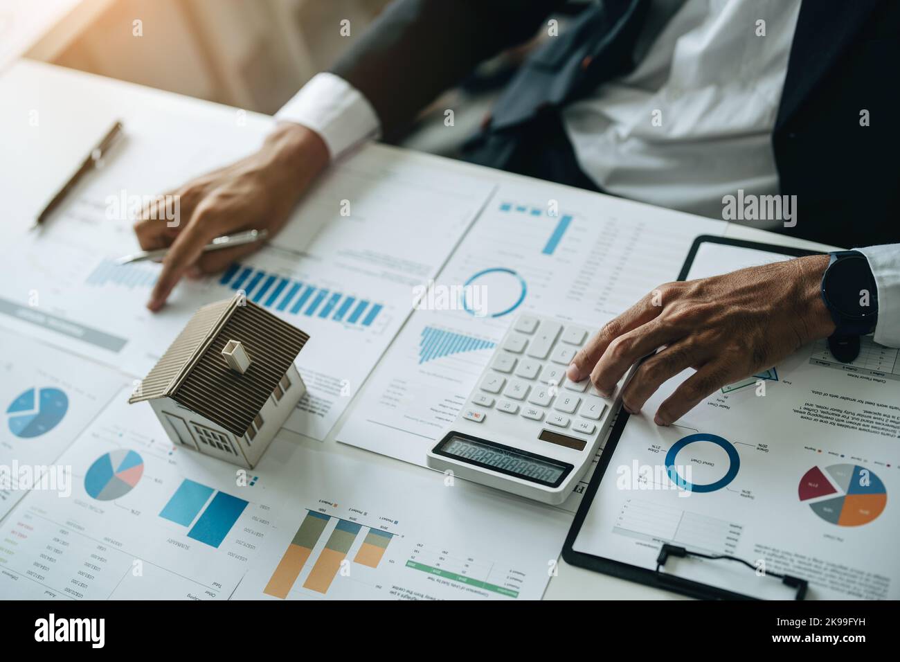 Bank loan workers are using calculators to calculate home loan interest