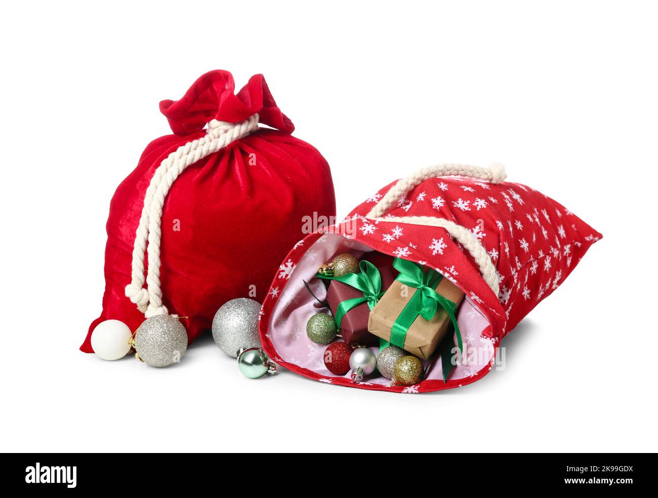 Santa Claus bags with decorations and gifts on white background Stock ...