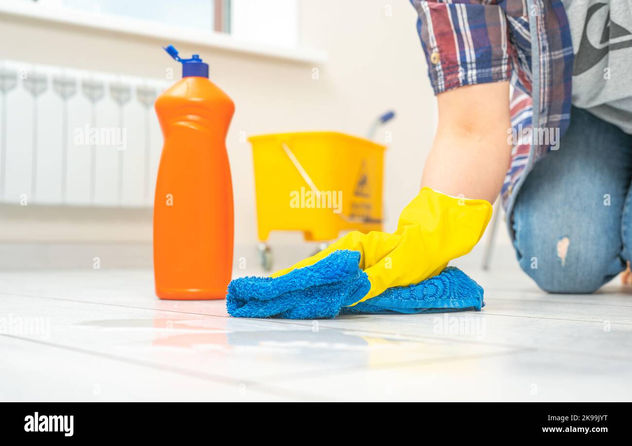 cleaning service. Man wearing gloves cleaning floor with microfiber
