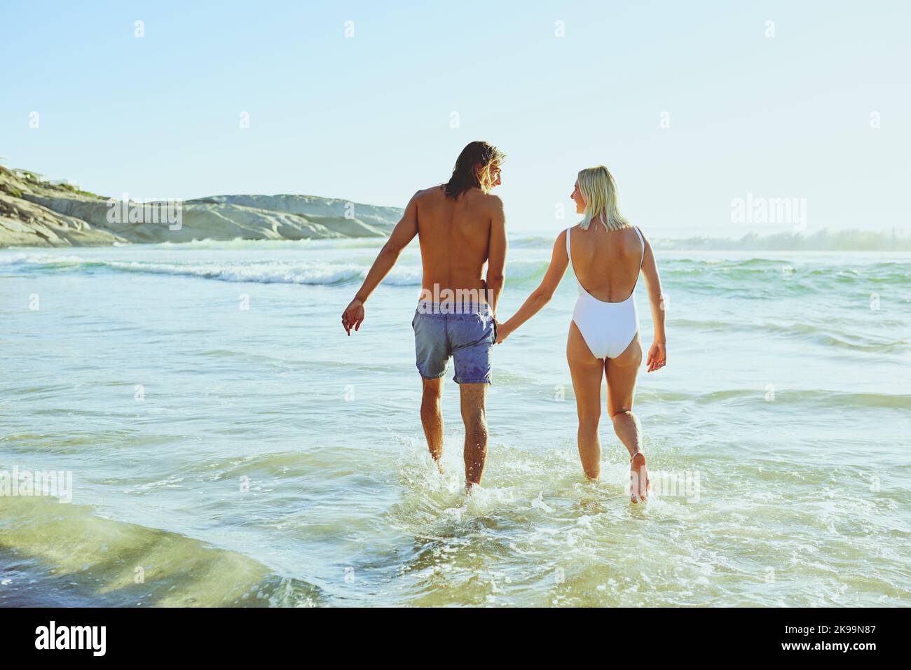 The beach is a place of ultimate joy. Rearview shot of a young couple enjoying some quality time together at the beach. Stock Photo