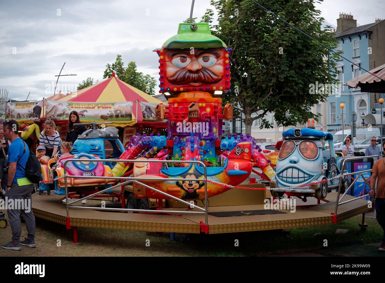 Colorful carousel with toy vehicles as seats at the Seafront Fun Fair