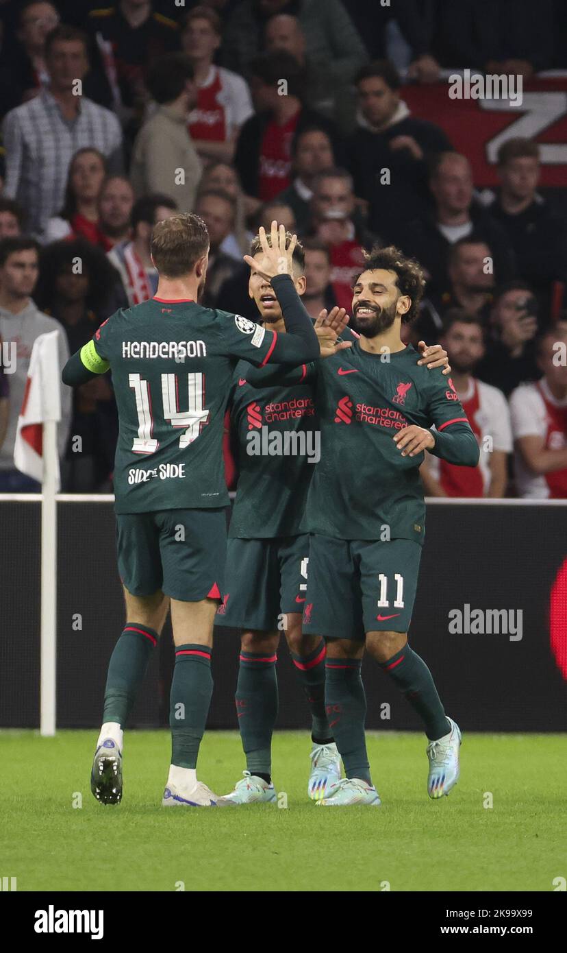 Amsterdam, Netherlands - October 26, 2022,  Mohamed Salah of Liverpool (right) celebrates his goal with Jordan Henderson of Liverpool during the UEFA Champions League, Group A football match between Ajax Amsterdam and Liverpool FC on October 26, 2022 at Johan Cruijff ArenA in Amsterdam, Netherlands - Photo: Jean Catuffe/DPPI/LiveMedia Stock Photo