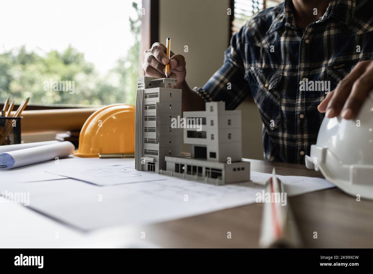 Architect man working with blueprints for architectural plan, engineer